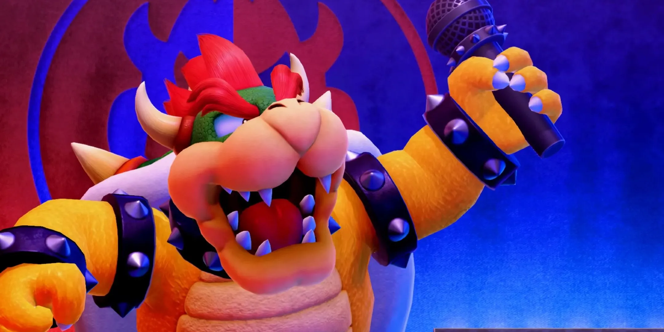 Bowser trên sân khấu với micro, thể hiện hình ảnh kẻ phản diện thường bắt cóc các công chúa trong thế giới game Super Mario.
